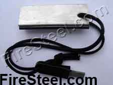 A slab of pure Magnesium with an attached FireSteel.com FireSteel.  The mag slab has a neatly drilled lanyard hold through which is strung a lanyard made from genuine 550-parachute cord with a FireSteel.com Super Scraper