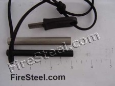 Our FireSteel.com Survival FireSteel with neatly centered lanyard hole, a genuine 550-parachute cord lanyard, along with a Super Scraper and 3-inch Magnesium Tinder Rod